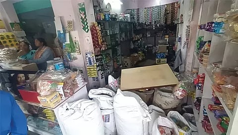 மளிகை கடைக்குள் இருந்து பணம் திருடப்பட்டு பொருள்கள் கலைந்து கிடப்பதை படத்தில் காணலாம்.