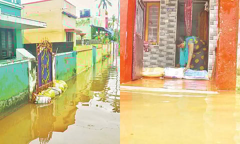 பிள்ளைத்தோப்பு பகுதியில் குடியிருப்புகளை சூழ்ந்திருக்கும் மழை நீர் - மழை நீர் வீடுகளுக்குள் புகாமல் இருக்க வாசலில் மணல் மூட்டைகளை அடுக்கிய பெண்ணை காணலாம்
