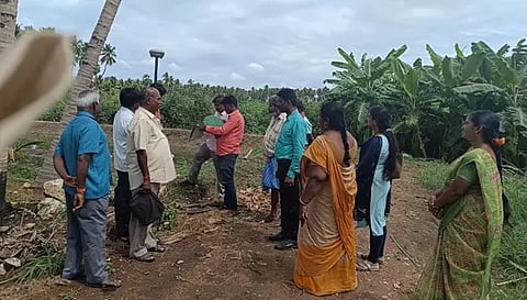 கோவிலுக்கு சொந்தமான இடத்தை அதிகாரிகள் அளவீடு செய்த போது எடுத்த படம்.