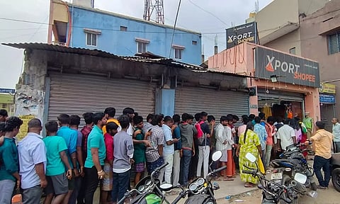 ஜவுளிக்கடை முன்பு பொதுமக்கள் நீண்ட வரிசையில் நின்றிருந்த காட்சி.