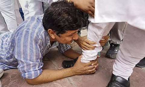 பா.ஜ.க. எம்.எல்.ஏ.வின் காலில் விழுந்து கெஞ்சிய மந்திரி- டெல்லியில் பரபரப்பு