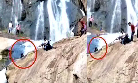 அருவி பாறையில் சிக்கி அந்தரத்தில் தொங்கிய மதுரை வாலிபர் - கயிறு கட்டி மீட்ட பொதுமக்கள்