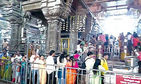 கோவிலில் சாமி தரிசனம் செய்ய வரிசையில் காத்திருந்த பக்தர்கள்.