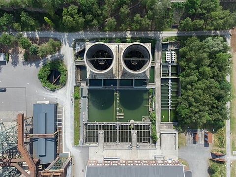 Aerial view of an industrial plant with two large cooling towers