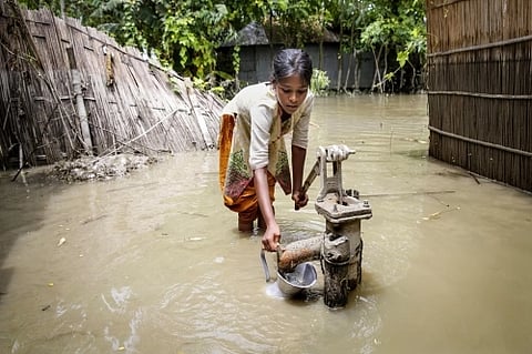 Children accessing a community water point in a climate-affected area.