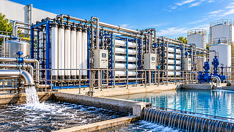 Modern industrial water treatment facility with membrane filtration units, reverse osmosis systems, stainless-steel pipelines, pumps and treated-water basins for wastewater reclamation and reuse.