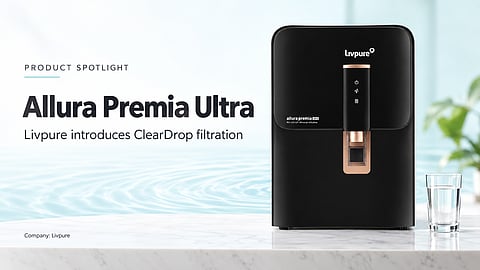 Black Livpure Allura Premia Ultra purifier with copper-coloured dispenser beside a glass of water.