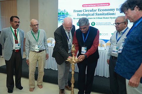 Delegates light a ceremonial lamp at the international conference on ecological sanitation and circular economy.