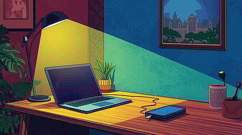 A modern Indian home office setup featuring a sleek sustainable laptop on a bamboo desk organizer, illuminated by energy-efficient lights