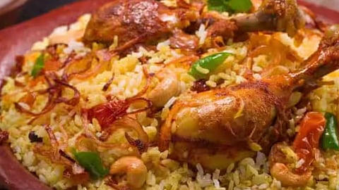 Biryani served in traditional dum style, garnished with fried onions and boiled eggs.