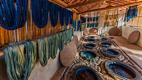 Fabric and threads dyed indigo blue in vats of blue hues