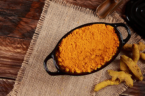 Tumeric in a bowl, for dyeing white cotton fabric yellow.