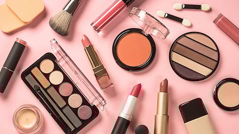 All make-up tools and products laid out on flat surface.