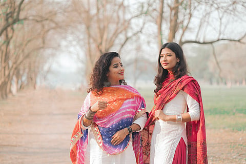 Women modelling wearing salawar kameez.