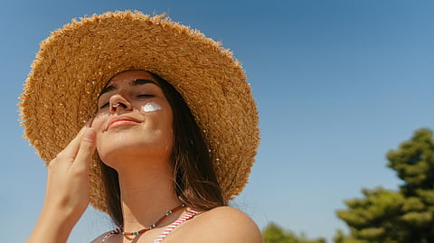 A women wearing sunscreen on a sunny day.