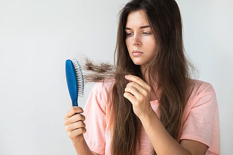 A women concered about her hair fall.