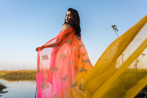 A Indian women wearing a colorful ethnic dress.