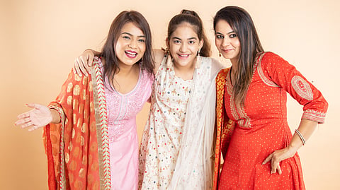 Indian women wearing colourful combinations of ethnic wear.