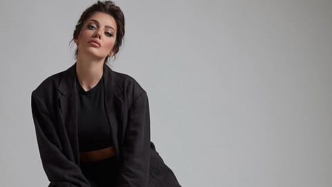 A women in dark black pant suit set.