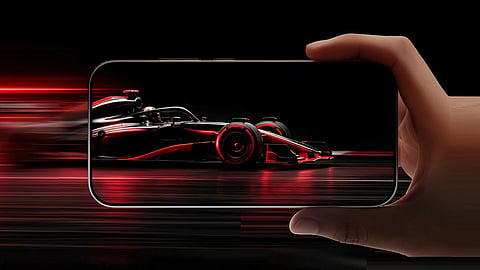 Official Redmi Turbo 5 promotional image showing the phone in landscape mode with a Formula racing game on the display.