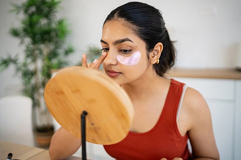 Women applying eye mask.
