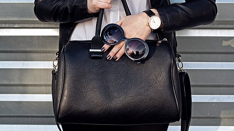 A women carrying her laptop bag for business trip.