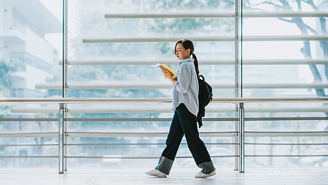 A women commuting to work with her laptop backpack.