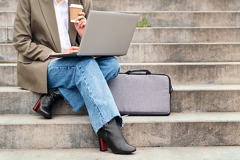 Women working with her work laptop and laptop bag.