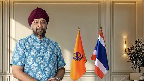 An image of S Pinderpal Singh Madan standing near a chair in a room at Siri Guru Singh Sabha Association