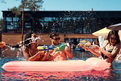 Group of Young Smiling Friends having Fun in Pool.