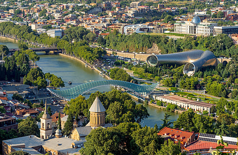 The aerial view of Tbilisi city Georgia from Narikala fortress.River Mtkvari, ancient orthodox church Sioni, Bridge of Peace and Rhike Park Music Theater and Exhibition Hall