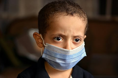 a child wearing a face mask