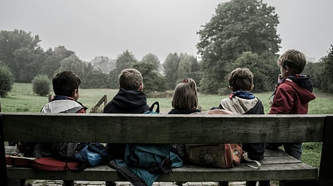 Kids sitting on a bench