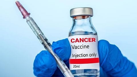 A person holds a syringe and a bottle labeled as a cancer vaccine, preparing for a medical procedure.
