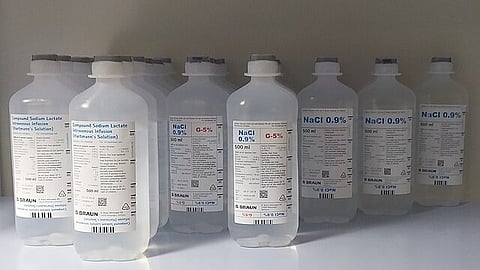 Multiple bottles of sodium chloride solution used for medical purposes.