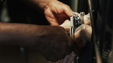 Handcuffs on Hands of Prisoner in Jail