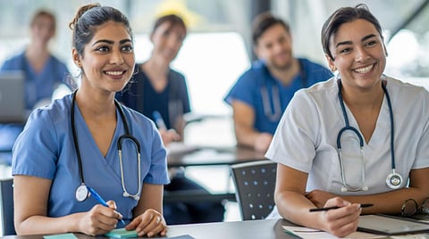 Medical students in a class wearing scrubs. 