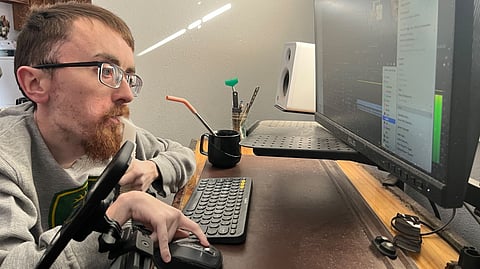 Zach Mecham working at his online marketing business.