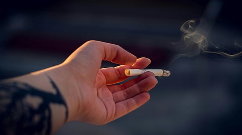 Close-Up Photography of a Person Holding Cigarette