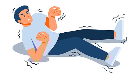 A man lying on the floor with his head elevated, representing a seizure event.