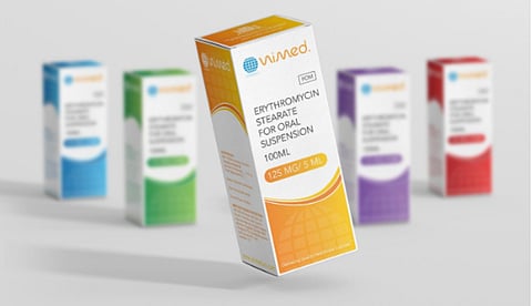 A box containing various colored bottles, all featuring the same label design.