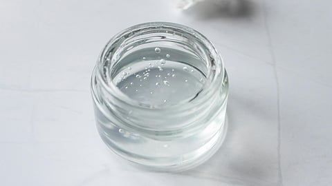 A glass container containing thick transparent gel