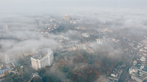 An aerial view of a city with air pollution.