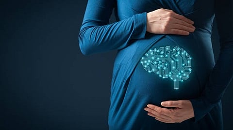 A pregnant woman in a blue dress cradles her belly, featuring a graphic of a brain made of circuit patterns.