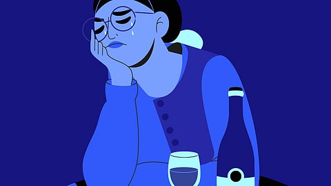 An illustration showing a woman crying over a glass of wine.