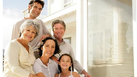 A family picture of grandparents, parents and a young girl.
