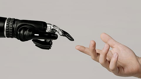 A robotic arm and a human hand trying to connect through their fingertips.