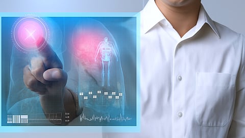 A doctor interacts with a digital medical screen, overlaying a human figure and X-ray image of lungs.