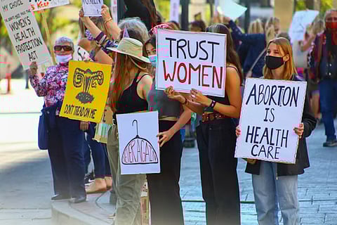 A group of people holding signs and protesting in support of women’s rights and reproductive freedom.