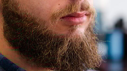 Close-up showing the beard of a man with a blurred background.